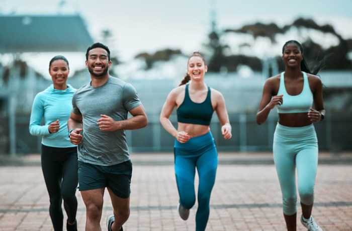 Men and woman running together in an urban area